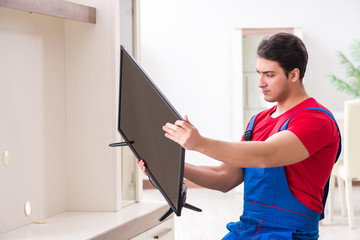 Professional repair engineer repairing broken tv