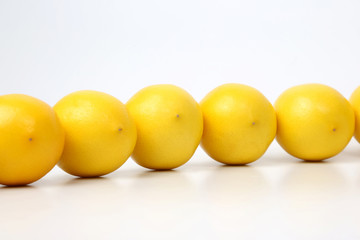 whole lemons together on white background