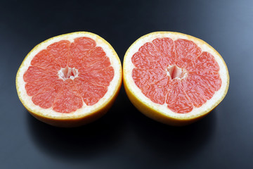 cut grapefruit on a dark background