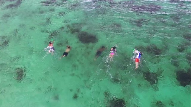 Anfibia board practicing water sports in the tropics.  Adventure sports in Caribbean waters with coral reefs. Practicing risky sports on spectacular turquoise seabeds. Coral Cay in Bocas del Toro.