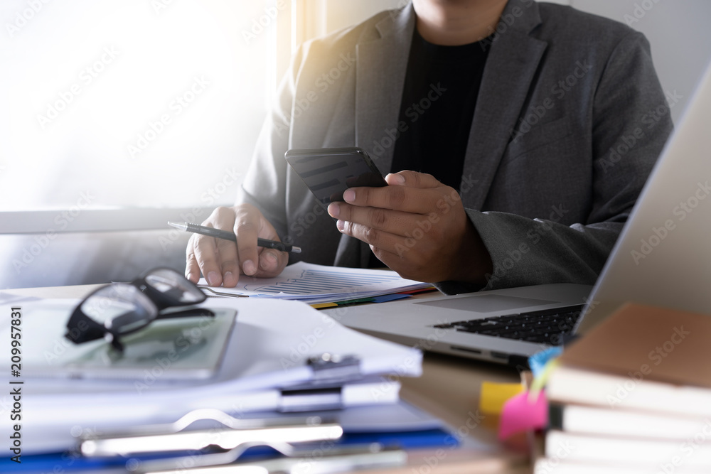 Poster businessman using phone smart phone and notebook computer