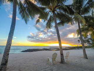 Two deck chairs under palm trees at sunset on an empty beach at Lefaga, Matautu, Upolu Island,...