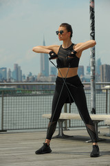Female fitness model working out outdoor. Concept of healthy lifestyle.