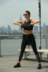 Female fitness model working out outdoor. Concept of healthy lifestyle.