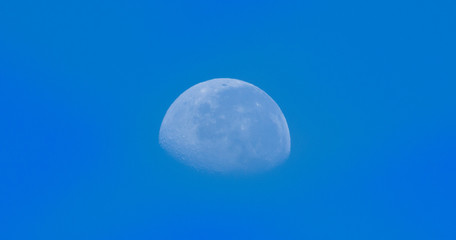 Crescent moon in blue sky