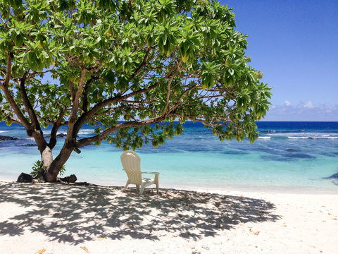 Solitude - a single deckchair for relaxation in the shade on a beautiful tropical sandy beach at Lefaga, Matautu, Upolu Island, Samoa, South Pacific