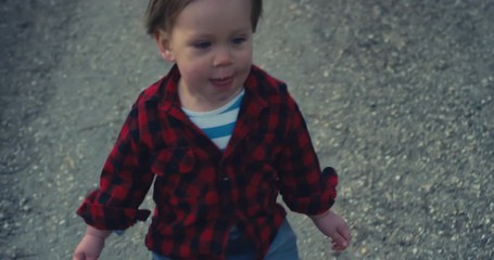 Little toddler boy walking on path