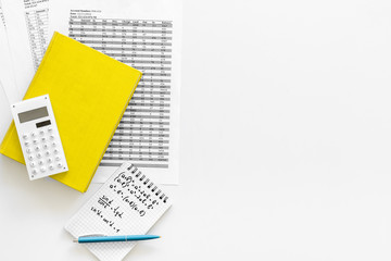 Math homework. Math textbook or tutorial near sheet with numbers, countes, calculator, notebook with formula on white background top view copy space