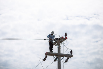 14 june 2018:The electricians are repairing and putting on new wires to keep up the light at night. Must use specialized capabilities in the work In Phetchaburi Province, Thailand