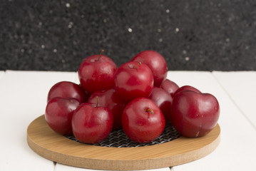 Fresh red plums, on white background.

