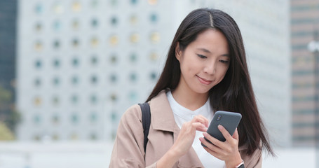 Business woman look at mobile phone