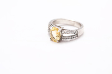 Yellow gem stone on diamond ring