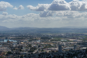 Fototapeta na wymiar View from the top to city of Haifa in Israel and harbor at spring time.