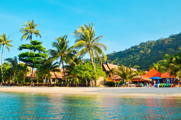 Tropical sandy beach with palm trees and tropical forest. Shooting from the sea. Thailand, Koh Chang Island