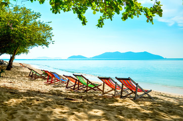 Empty beds are in a row on the beach. Tanning place on the sea