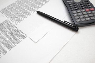 printout paper with calc and pen on desk