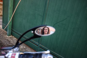 woman in the motorcycle mirror