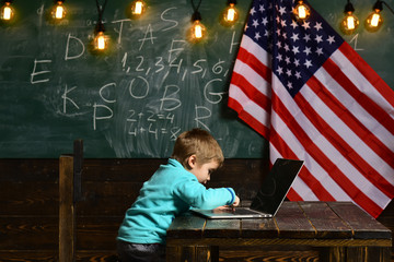 E-learning of little kid, E-learning of boy at school with americal flag on independence day.