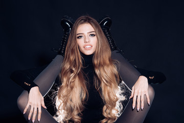 Girls only Lady cool make up long hair holds skinny legs in shoes. Girl attractive holds legs of another woman black background. Girlish essence concept. Legs slim black tights and brutal boots