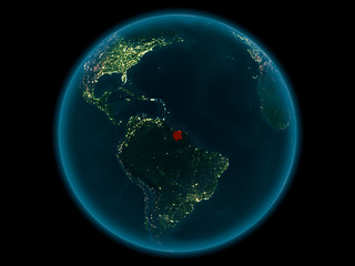 Suriname on planet Earth in space at night
