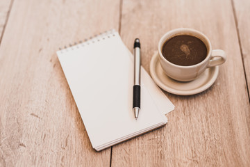 Obraz na płótnie Canvas Blank Notebook with Coffee on Wood Board.