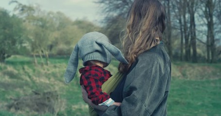 Little toddler boy with his mother in forest