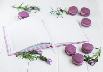 French macaroons, clean notebook and lavender flowers