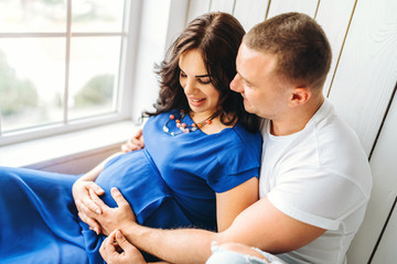 Fototapeta premium Cute pregnant woman with her happy husband