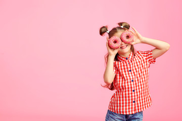 Girl with donuts on a pink background.