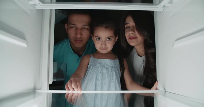 sad asian family looking in empty refrigerator, searching for products and finds nothing...