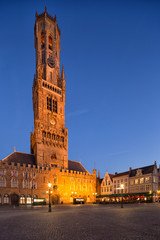 Fototapeta premium Belfort van Brugge - famouse 12th-century belfry Belfort of Bruges and Grote Markt square, Belgium.