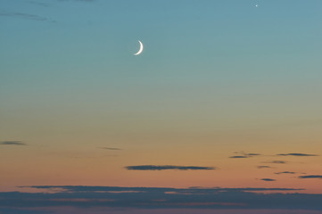 Fototapeta premium crescent in the sunset sky on the seashore