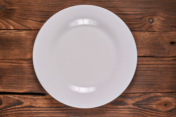 pure white plate on wooden background