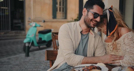 Young tourists couple having breakfast at coffee shop in Italy - Powered by Adobe