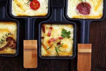 Delicious traditional Swiss melted raclette cheese on diced boiled or baked potato.