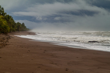 Dramatic sky and a stormy sea at a beach in Tortuguero National Park, Costa Rica