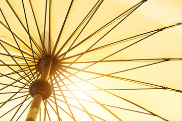 summer season coming, yellow umbrella low angle view under sunshine