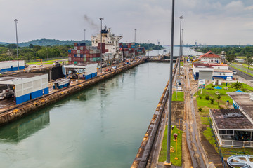 GATUN, PANAMA - MAY 29, 2016: Container ship is  passing through Gatun Locks, part of Panama Canal.