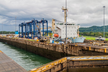 Cargo ship is  passing through Gatun Locks, part of Panama Canal