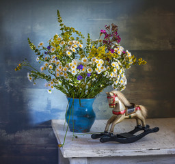 still life with flowers and a wooden toy. vintage.