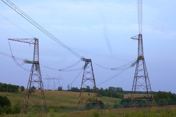 high-voltage power line in the field with a red stripe