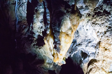 Illuminated multicolored stalactites in cave HAN-SUR-LESSE