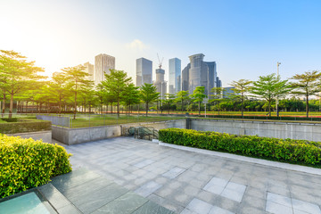 Empty square floor and modern commercial building at sunrise in Shenzhen
