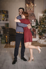 Couple in the living room decorated for Christmas and New Year