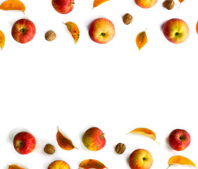 Ripe yellow red juicy apples with leaves and walnuts autumn on white background with space for text. Top view, flat lay