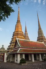 Fototapeta na wymiar Pagoda is in Wat Pho that was named as the temple of the pagoda or chedi that are decorated with yellow glaze or glazed tiles or dark blue. 