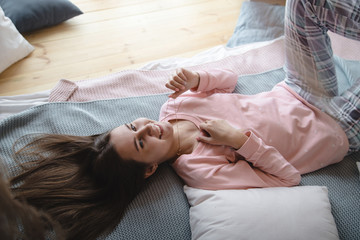 Cute girl in pink pajamas on the bed