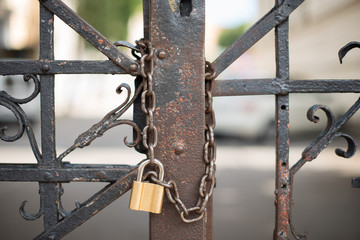 Locked doors with chain and golden lock