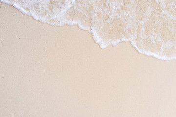 Beautiful beach with soft wave of the sea on the sandy beach. Ocean waves in sunny summer day, clear sea beach.