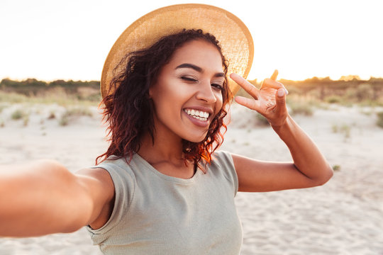 Happy young excited african lady make selfie